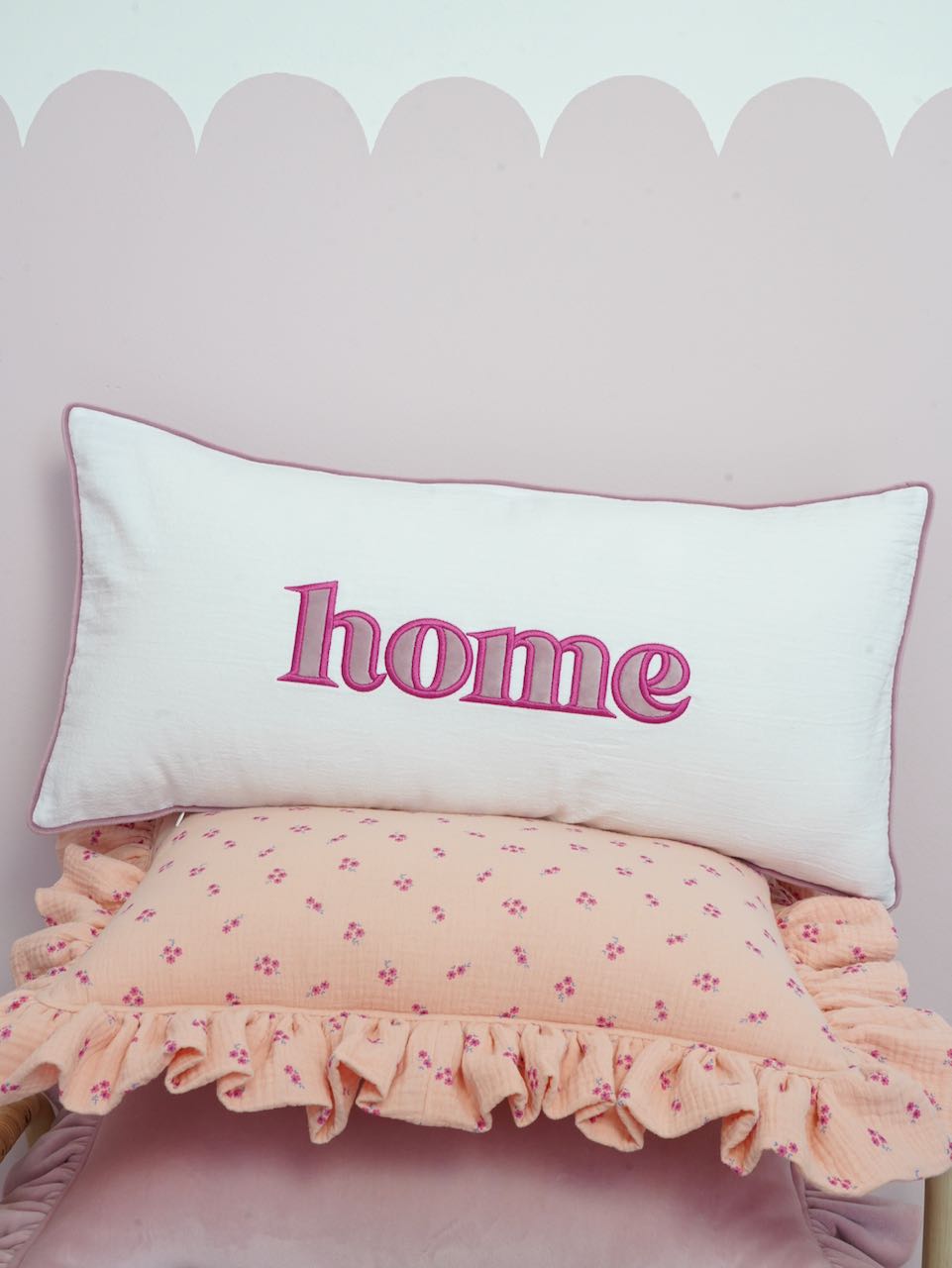 Decorative pillowcase with a pink embroidered inscription "Home"