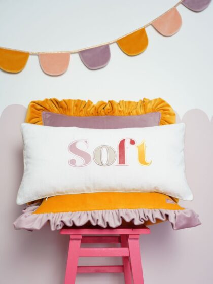 Decorative pillowcase with a colorful embroidered inscription "Soft"