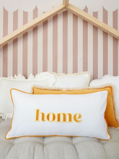 Decorative pillowcase with a yellow embroidered inscription "Home"
