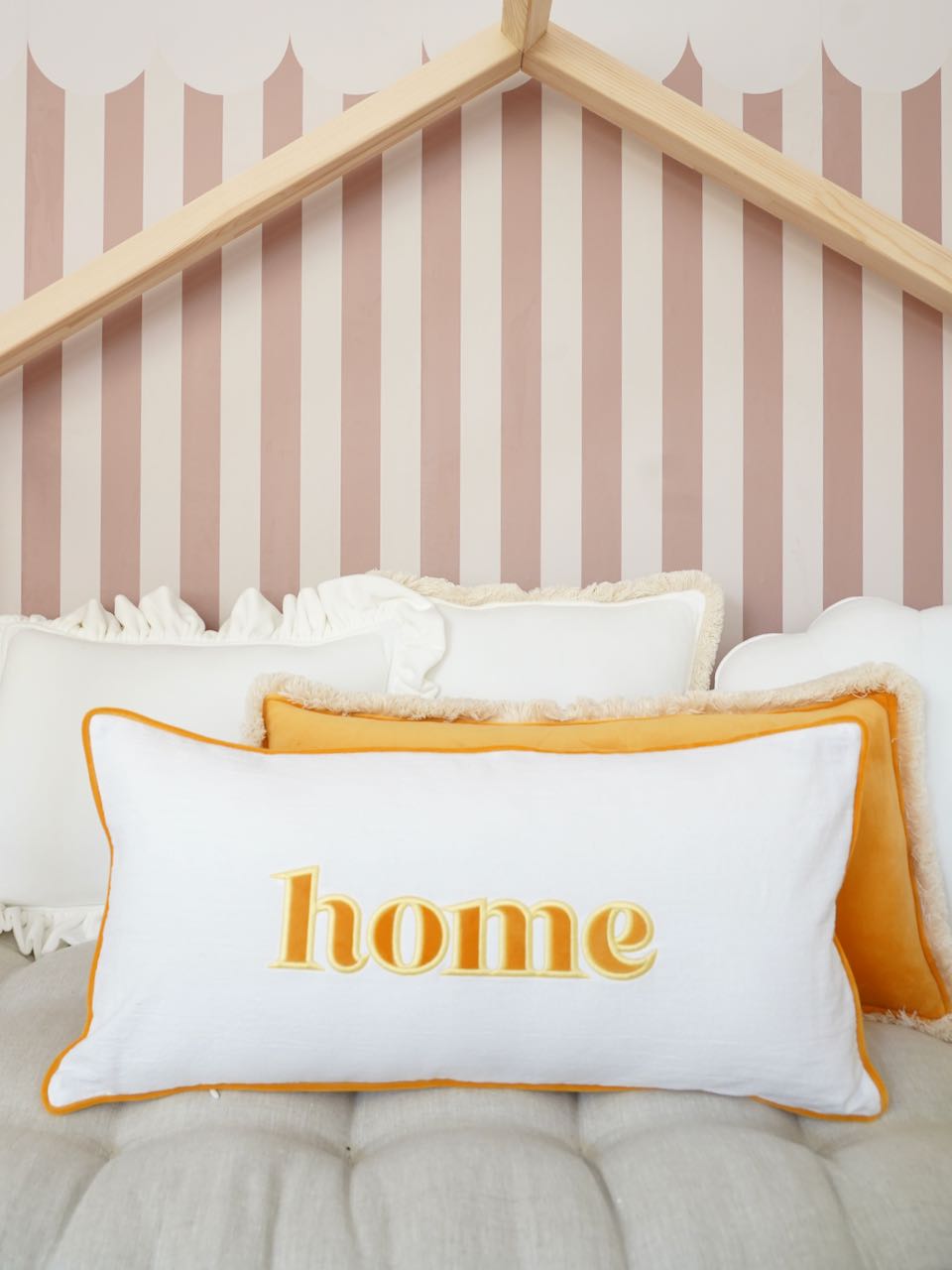 Decorative pillowcase with a yellow embroidered inscription "Home"