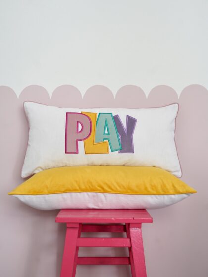 Decorative pillowcase with a colorful embroidered inscription "Play 3"
