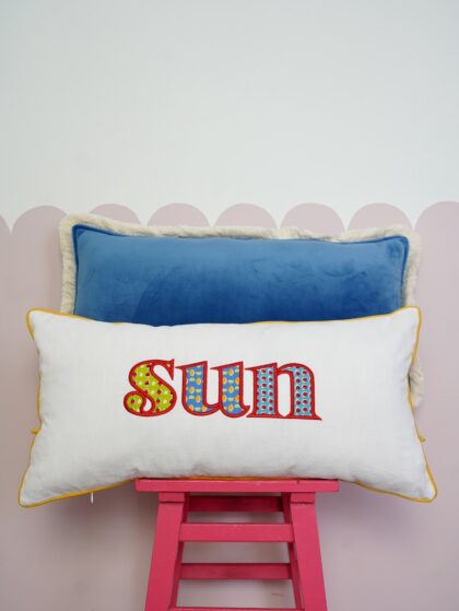Decorative pillowcase with a colorful embroidered inscription "Sun"